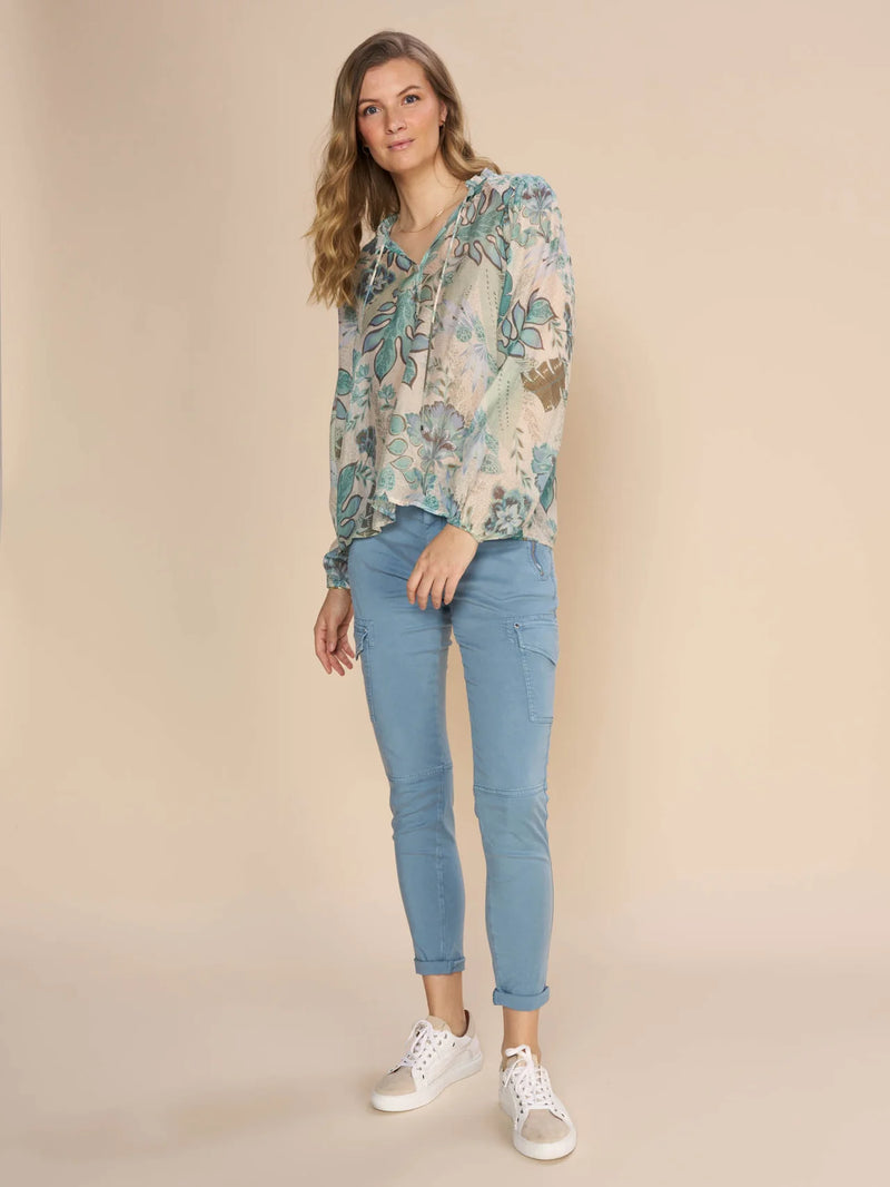 Mos Mosh Eisa Sarasa blouse. This trendy and flattering blouse is crafted in a floral print.  Front draw string neck line with elastic detail at wrists.Light weight feminine comfortable fabric. Can be paired with ad ressy pant or casual slim fitting pant. 