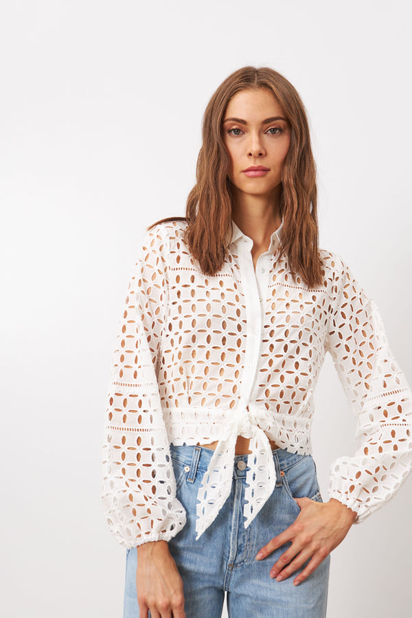 Elegant broderie anglaise cotton blouse featuring a delicate waist knot for a touch of femininity
