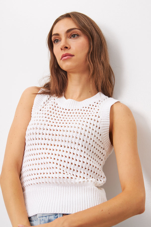 Sleeveless top Made with a soft, breathable cotton blend, this sleeveless top features a round neck and delicate perforated knit design. Available in white and in black this timeless piece will elevate any outfit. 
