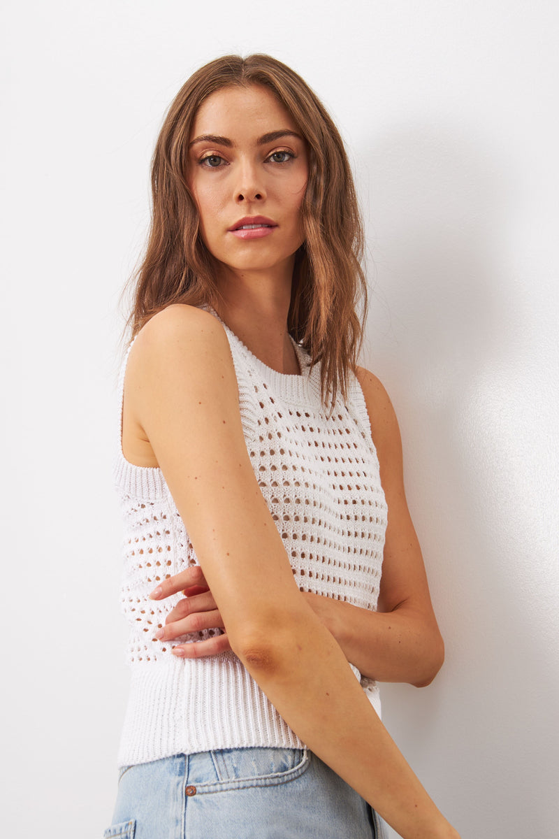Sleeveless top Made with a soft, breathable cotton blend, this sleeveless top features a round neck and delicate perforated knit design. Available in white and in black, this timeless piece will elevate any outfit. 